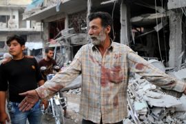 A Syrian man with a blood stained shirt gestures near debris following a reported Russian air strike in the district of Jisr al-Shughur, in the Idlib province, on September 25, 2017. Russian air strikes on northwest Syria's mainly jihadist-controlled province of Idlib killed at least 37 civilians including 12 children, a Britain-based monitor said. / AFP PHOTO / Mohamed al-Bakour (Photo credit should read MOHAMED AL-BAKOUR/AFP/Getty Images)