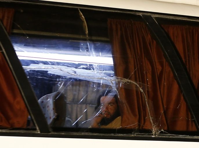 A member of the Islamic State (IS) group looks out of the window of a bus in the Qara area in Syria's Qalamoun region on August 28, 2017 as IS members and their families are transported to Deir Ezzor under part of an unprecedented deal to end three years of jihadist presence.Under the evacuation deal, several hundred jihadists and their families on both sides of the border are set to leave by bus for Deir Ezzor in eastern Syria, the country's only province still under IS control. / AFP PHOTO / LOUAI BESHARA (Photo credit should read LOUAI BESHARA/AFP/Getty Images)