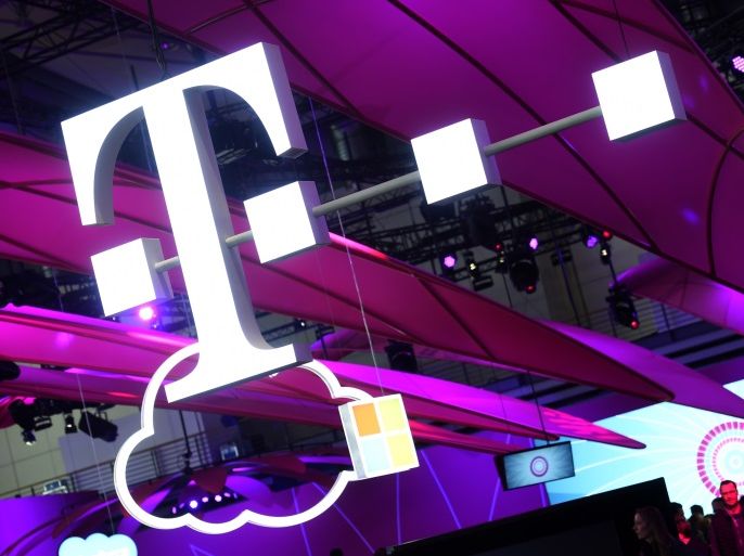Deutsche Telekom logo is seen during preparations at the CeBit computer fair, which will open its doors to the public on March 20, at the fairground in Hanover, Germany, March 18, 2017. REUTERS/Fabian Bimmer