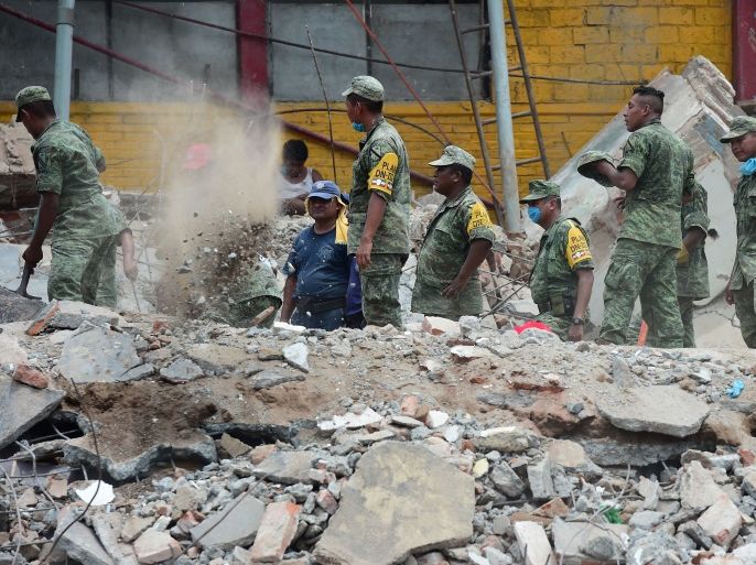 Mexican Army and Navy members remove rubble after the Town Hall building partially collapsed following an 8.2 earthquake that hit Mexico's Pacific coast, in Juchitan de Zaragoza, state of Oaxaca on September 8, 2017. Mexico's most powerful earthquake in a century killed at least 35 people, officials said, after it struck the Pacific coast, wrecking homes and sending families fleeing into the streets. / AFP PHOTO / RONALDO SCHEMIDT (Photo credit should read RONALDO SCHEMIDT/AFP/Getty Images)