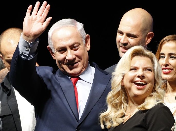 Israeli Prime Minister Benjamin Netanyahu and his wife Sara react during a gathering by Likud party members and activists at the Tel Aviv Convention Center on August 9, 2017 in a mass show of support for the PM who is facing a string of corruption investigations. / AFP PHOTO / Jack GUEZ (Photo credit should read JACK GUEZ/AFP/Getty Images)