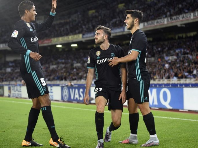 Real Madrid's forward from Spain Borja Mayoral (C) is congratulated by teammates Real Madrid's defender from France Raphael Varane (L) and Real Madrid's midfielder from Spain Marco Asensio after scoring the opening goal during the Spanish league football match Real Sociedad vs Real Madrid CF at the Anoeta stadium in San Sebastian on September 17, 2017. / AFP PHOTO / ANDER GILLENEA (Photo credit should read ANDER GILLENEA/AFP/Getty Images)