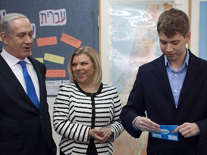epa03549468 Israeli Prime Minister Benjamin Netanyahu with his wife Sara watch their son Yair voting at a polling station on election day 22 January 2013 in Jerusalem, Israel. Israelis begin voting in a general election, with opinion polls suggesting Prime Minister Benjamin Netanyahu will win another term, with a reduced majority. EPA/Uriel Sinai / POOL