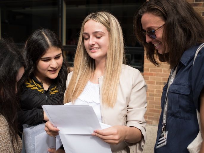 LONDON, UNITED KINGDOM - AUGUST 24: A student is congratulated by friends as as she receives her GCSE exam results at Stoke Newington School and Sixth Form on August 24, 2017 in London, United Kingdom. The GCSE pass rate has dropped this year, following the introduction of harder exams. (Photo by Leon Neal/Getty Images)