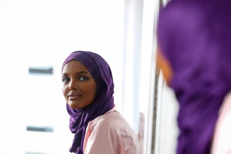 Fashion model and former refugee Halima Aden, who is breaking boundaries as the first hijab wearing model gracing magazine covers and walking in high profile runway shows looks in a mirror as she has her makeup applied during a shoot at a studio in New York City, U.S .August 28, 2017. Photo taken August 28, 2017. REUTERS/Brendan McDermid