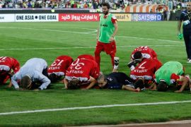 Syria's players pray at the end of their FIFA World Cup 2018 qualification football match against Iran at the Azadi Stadium in Tehran on September 5, 2017. / AFP PHOTO / ATTA KENARE (Photo credit should read ATTA KENARE/AFP/Getty Images)