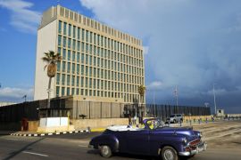 TOPSHOT - An old American car passes by the US Embassy in Havana on December 17, 2015. The United States announced Thursday the resumption of regular flights to and from Cuba, the latest step in a historic thaw in relations. 'On December 16, the United States and Cuba reached a bilateral arrangement to establish scheduled air services between the two countries,' the State Department said in a statement. / AFP / YAMIL LAGE (Photo credit should read YAMIL LAGE/AF