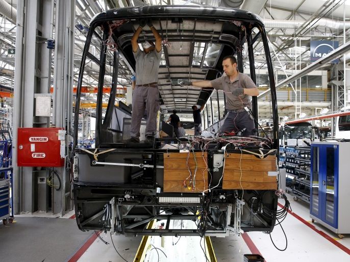 Employees work at the assembly line of the MAN Bus Production Center in Ankara, Turkey, July 29, 2015. According to a statement from the company, it employs 1,600 workers on the 320,000 square metre plant where seven vehicles are produced a day to be used for the MAN and NEOPLAN brand of city and intercity buses, as well as touring coaches. Picture taken July 29, 2015. REUTERS/Umit Bektas