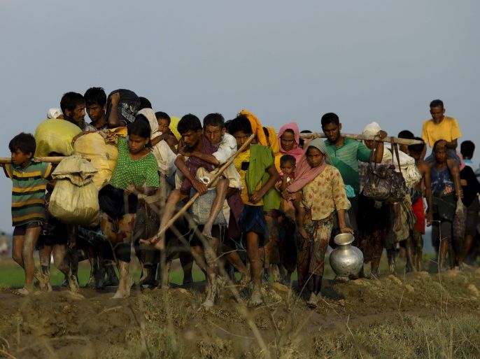 Displaced Rohingya refugees from Rakhine state in Myanmar carry their belongings as they flee violence, near Ukhia, near the border between Bangladesh and Myanmar on September 4, 2017.A total of 87,000 mostly Rohingya refugees have arrived in Bangladesh since violence erupted in neighbouring Myanmar on August 25, the United Nations said today, amid growing international criticism of Aung San Suu Kyi. Around 20,000 more were massed on the border waiting to enter, the UN said in a report. / AFP PHOTO / K.M. ASAD (Photo credit should read K.M. ASAD/AFP/Getty Images)