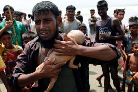 Nasir Ahmed, a Rohingya refugee man cries as he holds her 40-day-old son, who died as a boat capsized in the shore of Shah Porir Dwip while crossing Bangladesh-Myanmar border, in Teknaf, Bangladesh, September 14, 2017. REUTERS/Mohammad Ponir Hossain