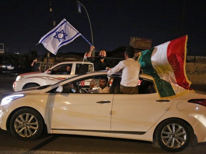 Iraqis Kurds carry the Kurdish and the Israeli flags in the streets of the northern city of Kirkuk on September 25, 2017 following a referendum on the independence. Iraq's Kurds defied widespread opposition to vote in a historic independence referendum, sparking fresh tensions with Baghdad, threats from Turkey and fears of unrest. The vote in the autonomous Kurdish region of northern Iraq and some disputed areas is non-binding and will not lead automatically to indepen
