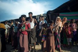 TOPSHOT - Rohingya Muslim refugees watch a food distribution at Balukhali refugee camp in Bangladesh's Ukhiya district on October 4, 2017.More than 500,000 Muslim Rohingya have fled ethnic bloodshed in Myanmar in the past month and numbers are again swelling, with Bangladesh reporting 4-5,000 civilians now crossing the border each day after a brief lull in arrivals. / AFP PHOTO / FRED DUFOUR (Photo credit should read FRED DUFOUR/AFP/Getty Images)