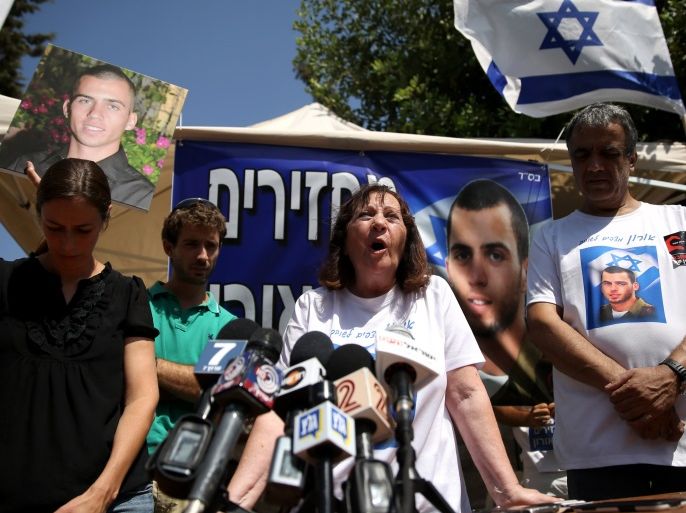 Israeli Zehava Shaul, the mother of slain Israeli soldier Oron Shaul, who was killed in Gaza during the summer of 2014's 50-day military campaign against Hamas and body's has not been recovered, speaks during a press conference on June 29, 2016 next to her husband Herzel (R) at their protest tent outside thr prime minister's residence in Jerusalem. Zur (L) and Ayelet Goldin whose brother Israeli army Lt. Hadar Goldin was also killed in Gaza and his body is believed to be held by Hamas, are also seen in the picture. The Israeli army believes they were killed and Hamas has yet to provide reliable evidence to counter that. / AFP / GALI TIBBON (Photo credit should read GALI TIBBON/AFP/Getty Images)