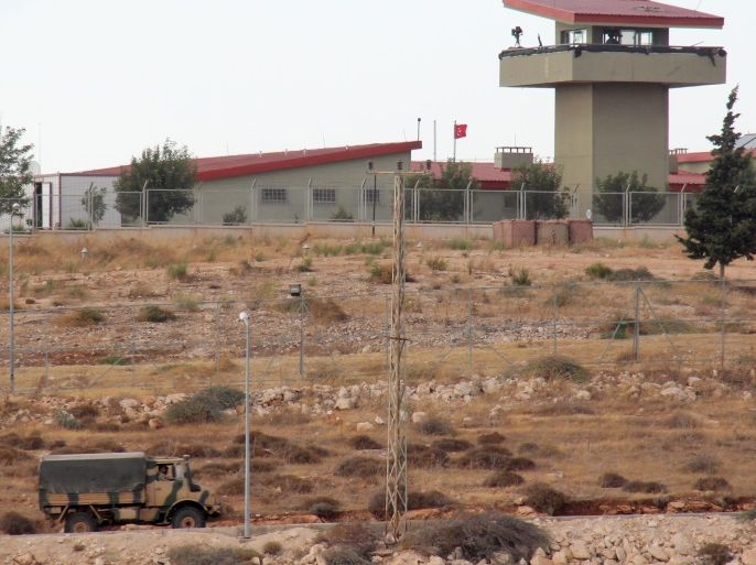 A picture taken on October 11, 2017, from the Syrian village of Atme in the northwestern province of Idlib shows Turkish military vehicles driving around a military base on the Turkish side of the border with Syria.Turkey-backed Syrian rebels are preparing for an operation to oust jihadists from the northwestern province of Idlib. Early this week, Turkey's army said it had launched a reconnaissance mission in Idlib days after President Recep Tayyip Erdogan announced an