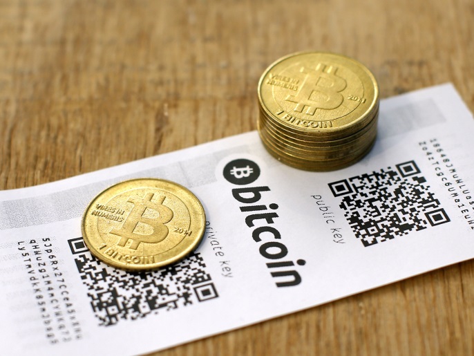 A Bitcoin (virtual currency) paper wallet with QR codes and coins are seen in an illustration picture taken at La Maison du Bitcoin in Paris July 11, 2014. French police dismantled an illegal Bitcoin exchange and seized 388 virtual currency units worth some 200,000 euros ($272,800) in the first such operation in Europe a public prosecutor said on Monday. REUTERS/Benoit Tessier (FRANCE - Tags: BUSINESS)
