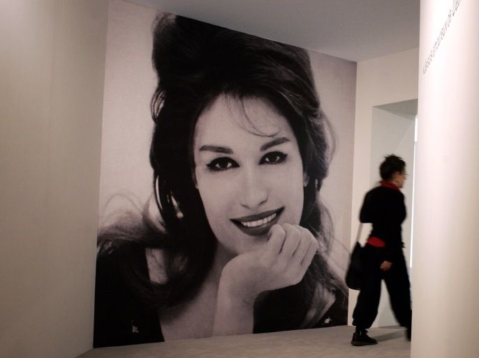 A person walks by a giant poster of Egyptian born singer Dalida during the inauguration of an exhibition dedicated to Dalida, 10 May 2007 in Paris, 20 years after she commited suicide in Paris. AFP PHOTO OLIVIER LABAN-MATTTEI (Photo credit should read OLIVIER LABAN-MATTEI/AFP/Getty Images)
