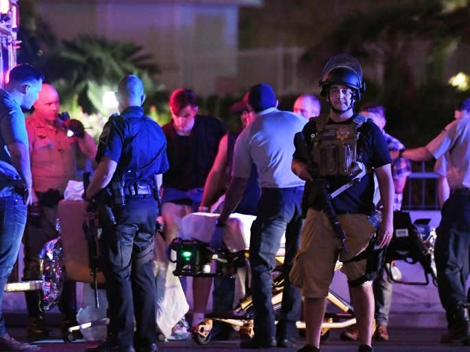 LAS VEGAS, NV - OCTOBER 02: Police officers stand by as medical personnel tend to a person on Tropicana Ave. near Las Vegas Boulevard after a mass shooting at a country music festival nearby on October 2, 2017 in Las Vegas, Nevada .A gunman has opened fire on a music festival in Las Vegas, leaving over 20 people dead. Police have confirmed that one suspect has been shot. The investigation is ongoing. (Photo by Ethan Miller/Getty Images)
