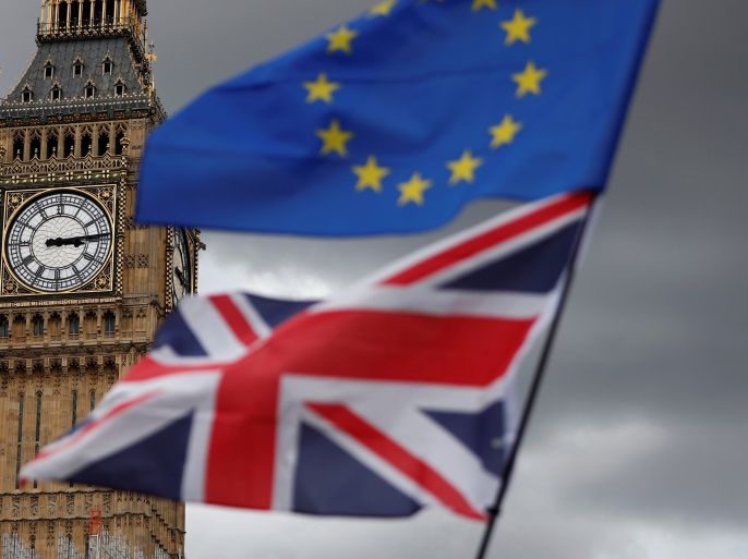 The Union Flag and a European Union flag fly near the Elizabeth Tower, housing the Big Ben bell, during the anti-Brexit 'People's March for Europe', in Parliament Square in central London, Britain September 9, 2017. REUTERS/Tolga Akmen