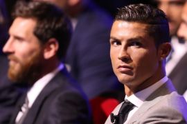 Real Madrid's Portuguese forward Cristiano Ronaldo (R) looks on alongside Barcelona's Argentinian forward Lionel Messi (L) as they wait ahead of the awarding of the title of 'Best Men's Player in Europe' at the conclusion of UEFA Champions League group stage draw ceremony in Monaco on August 24, 2017. / AFP PHOTO / VALERY HACHE (Photo credit should read VALERY HACHE/AFP/Getty Images)