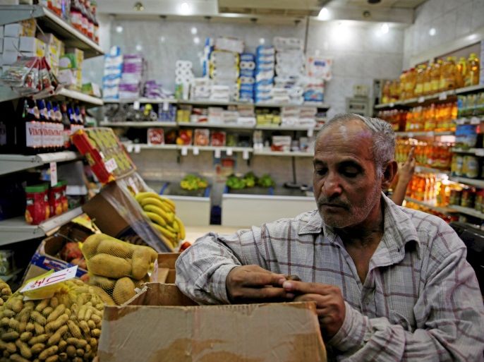 A worker goes about his day while waiting for customers at a supermarket in Cairo, Egypt, October 26, 2016. Picture taken October 26, 2016. REUTERS/Amr Abdallah Dalsh