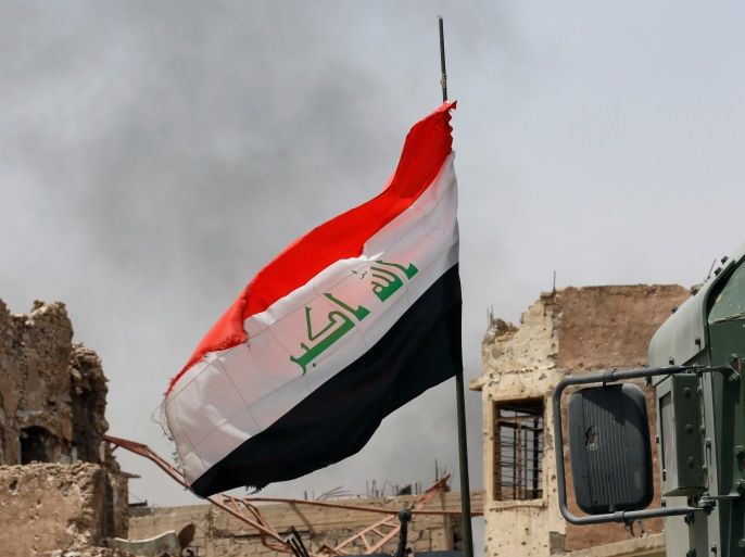 An Iraqi flag is seen during the fight with the Islamic States militants in the Old City of Mosul, Iraq July 3, 2017. REUTERS/Ahmed Jadallah