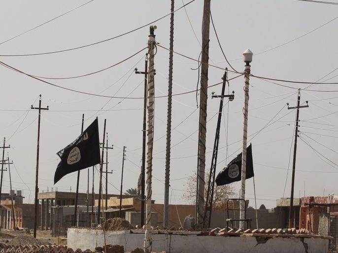 A general view shows Islamic State (IS) group flags in the northern Iraqi town of Sharqat on September 22, 2017, after Iraqi forces ousted the jihadists from the town. Iraqi forces achieved the first goal of a new offensive against the Islamic State group on just its second day, penetrating the northern town of Sharqat, AFP correspondents said. / AFP PHOTO / AHMAD AL-RUBAYE (Photo credit should read AHMAD AL-RUBAYE/AFP/Getty Images)