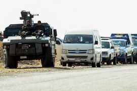 A picture taken on October 21, 2017 shows Egyptian security forces' vehicles and armoured personnel carriers (APCs) parked on the desert road towards the Bahariya oasis in Egypt's Western desert, about 135 kilometres (83 miles) southwest of Giza, near the site of an attack that left at least a dozen policemen killed in an ambush by Islamist fighters.An official statement said a number of the attackers were killed, but did not give any figures for losses on either side