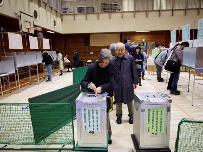 People line up to cast their ballots for Japan's general election at a polling station in Tokyo on october 22, 2017.Millions of Japanese braved typhoon conditions on October 22 for a snap election likely to hand Prime Minister Shinzo Abe a fresh mandate to revive the world's third-largest economy and press his hardline stance on North Korea. / AFP PHOTO / Behrouz MEHRI (Photo credit should read BEHROUZ MEHRI/AFP/Getty Images)