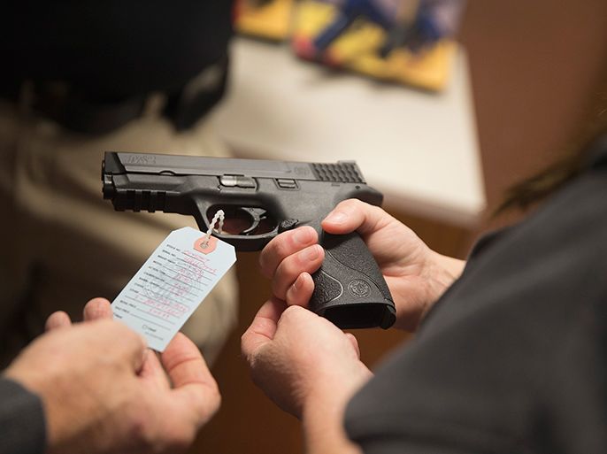 BRIDGETON, MO - NOVEMBER 12: Customers shop for a handgun at Metro Shooting Supplies on November 12, 2014 in Bridgeton, Missouri. The suburban St. Louis store is located near Ferguson, Missouri where several weeks of sometimes violent protests erupted following the shooting death of Michael Brown by Ferguson police officer Darren Wilson on August 9th. The gun shop last week experienced a 300 percent increase in sales over the same period last year. About 60 percent of those sales were from first-time gun owners. The increase is attributed in part to concern from residents of additional outbreaks of violence if the grand jury investigating Brown's death does not find justification to prosecute Wilson for the shooting. The grand jurys decision is expected sometime in November. (Photo by Scott Olson/Getty Images)2