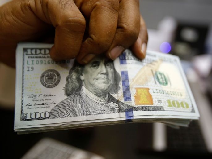 A dealer holds US dollars at a foreign exchange office in central Khartoum on October 12, 2017, after the lifting of the US trade embargo came into effect.Sudan's central bank said it had received its first overseas fund transfer in US dollars since Washington announced the lifting of a 20-year-old trade embargo against Khartoum. / AFP PHOTO / ASHRAF SHAZLY (Photo credit should read ASHRAF SHAZLY/AFP/Getty Images)