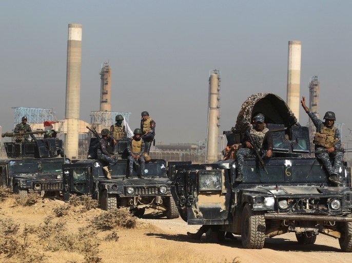 TOPSHOT - Iraqi forces drive past an oil production plant as they head towards the city of Kirkuk on October 16, 2017. / AFP PHOTO / AHMAD AL-RUBAYE (Photo credit should read AHMAD AL-RUBAYE/AFP/Getty Images)