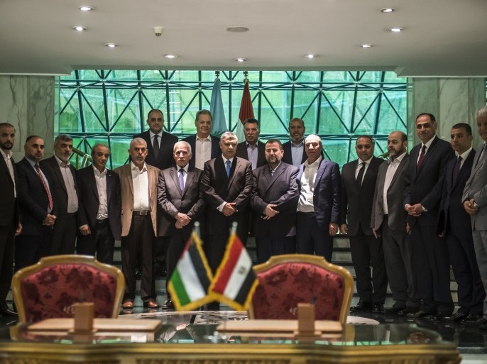 Khaled Fawzi (C), head of the Egyptian Intelligence services, Azzam al-Ahmad (C-L), head of the Fatah delegation for the talks, and Hamas' new deputy leader Salah al-Aruri (C-R) pose for a group picture with both Palestinian delegations following the signing of a reconciliation deal in Cairo on October 12, 2017, as the two rival Palestinian movements ended their decade-long split following negotiations overseen by Egypt.The new Hamas deputy leader and the head of Fatah's delegation struck the deal which was described by Palestinian Authority president Mahmud Abbas as a 'final agreement' to end their crippling division, which has at times erupted into deadly conflict over the past ten years. / AFP PHOTO / KHALED DESOUKI (Photo credit should read KHALED DESOUKI/AFP/Getty Images)
