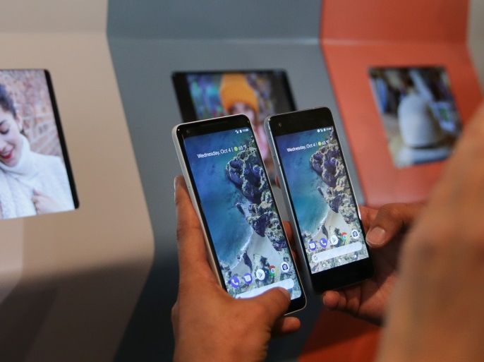 A member of the media holds up the new Pixel 2 and Pixel 2 XL smartphones at a product launch event on October 4, 2017 at the SFJAZZ Center in San Francisco, California.Google unveiled newly designed versions of its Pixel smartphone, the highlight of a refreshed line of devices which are part of the tech giant's efforts to boost its presence against hardware rivals. / AFP PHOTO / Elijah Nouvelage (Photo credit should read ELIJAH NOUVELAGE/AFP/Getty Images)
