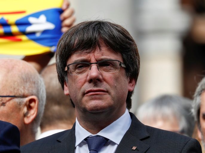 Catalan President Carles Puigdemont stands and other regional government members in Plaza Sant Jaume as they join a protest called by pro-independence groups for citizens to gather at noon in front of city halls throughout Catalonia, in Barcelona, Spain October 2, 2017. REUTERS/Juan Medina