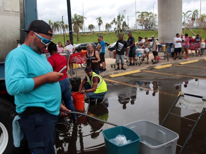 Local residents wait in line during a water distribution in Bayamon following damages caused by Hurricane Maria in Carolina, Puerto Rico, September 30, 2017 REUTERS/Alvin Baez