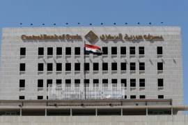 A Syrian national flag flutters on the Central Bank of Syria building in Damascus, Syria May 31, 2016. REUTERS/Omar Sanadiki