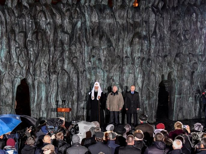 Russian President Vladimir Putin with Patriarch Kirill, the head of the Russian Orthodox Church, and former Human Rights Ombudsman Vladimir Lukin attend a ceremony unveiling the country's first national memorial to victims of Soviet-era political repressions called
