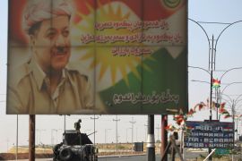 Iraqis forces keep position near a billboard bearing a portrait of Iraqi Kurdish leader Massud Barzani as they advance on the southern outskirts of Kirkuk on October 16, 2017. Iraqi forces seized the Kirkuk governor's office, key military sites and an oil field as they swept across the disputed province following soaring tensions over an independence referendum. / AFP PHOTO / AHMAD AL-RUBAYE (Photo credit should read AHMAD AL-RUBAYE/AFP/Getty Images)