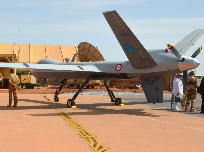 French army members of the Barkhane counter-terrorism operation in Africa's Sahel region stand next to a reaper drone at the Barkhane base near Niamey in Niger on July 31, 2017 during the visit of French Minister of Army. / AFP PHOTO / BOUREIMA HAMA (Photo credit should read BOUREIMA HAMA/AFP/Getty Images)