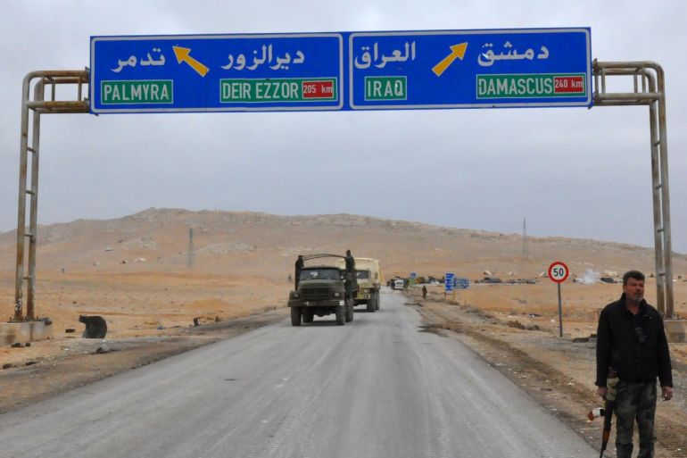 A picture taken on March 2, 2017, shows a sign displaying the routes to Palmyra-Deir Ezzor and Damascus-Iraq as Syrian regime fighters advance to retake the ancient city of Palmyra, from Islamic State (IS) group fighters. / AFP PHOTO / STRINGER        (Photo credit should read STRINGER/AFP/Getty Images)