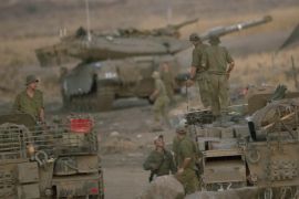 epa06202680 Israeli soldiers stand on top of their Israel tanks at a gathering site of Tanks and armored personnel carriers (APCs) in the Golan