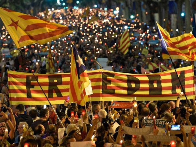People attend a candle-lit demonstration in Barcelona against the arrest of two Catalan separatist leaders on October 17, 2017.Catalonia braced for protests after a judge ordered the detention of two powerful separatist leaders, further inflaming tensions in the crisis over the Spanish region's chaotic independence referendum. / AFP PHOTO / LLUIS GENE (Photo credit should read LLUIS GENE/AFP/Getty Images)