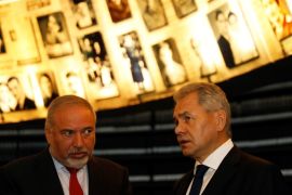 Russian Defence Minister Sergey Shoigu (R) stands next to his Israeli counterpart Avigdor Lieberman as as they look at pictures of Jews killed in the Holocaust during a visit to the Hall of Names at Yad Vashem's Holocaust History Museum in Jerusalem October 17, 2017. REUTERS/Ronen Zvulun