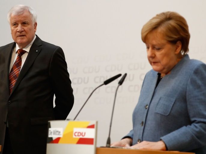 German Chancellor Angela Merkel, leader of the conservative Christian Democratic Union (CDU), and Horst Seehofer, leader of the CDU's Bavarian sister party Christian Social Union (CSU), give a press conference in Berlin on October 9, 2017, following talks to hammer out a common position concerning their asylum and immigration policy. / AFP PHOTO / Odd ANDERSEN (Photo credit should read ODD ANDERSEN/AFP/Getty Images)