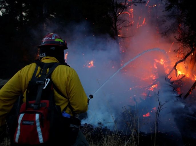 Firefighters battle a wildfire near Santa Rosa, California, U.S., October 14, 2017. REUTERS/Jim Urquhart