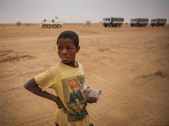 A local boy stands as a MINUSMA convoy pass by in the Gao region, Mali February 15, 2017. Each month MINUSMA organizes logistic convoys involving hundreds of civilians and military vehicles to supply remote UN bases in northern Mali. Picture taken February 15, 2017. MINUSMA/Sylvain Liechti handout via REUTERS ATTENTION EDITORS - THIS PICTURE WAS PROVIDED BY A THIRD PARTY.