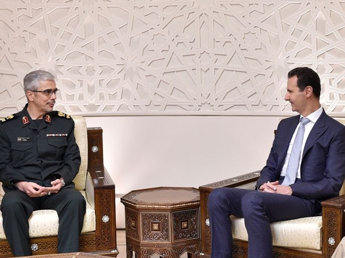 Iran's military chief, General Mohammad Baqeri meets with Syrian President Bashar al-Assad in Damascus, Syria in this handout picture provided by SANA on October 19, 2017. SANA/Handout via REUTERS ATTENTION EDITORS - THIS PICTURE WAS PROVIDED BY A THIRD PARTY. REUTERS IS UNABLE TO INDEPENDENTLY VERIFY THE AUTHENTICITY, CONTENT, LOCATION OR DATE OF THIS IMAGE.