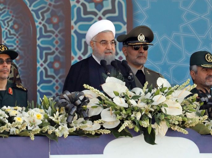 Iranian President Hassan Rouhani sits among senior army staff as he delivers his speech during the annual military parade marking the anniversary of the outbreak of its devastating 1980-1988 war with Saddam Hussein's Iraq, on September 22, 2017 in Tehran.Rouhani vowed that Iran would boost its ballistic missile capabilities despite criticism from the United States and also France. / AFP PHOTO / str (Photo credit should read STR/AFP/Getty Images)