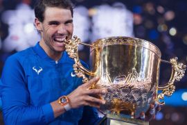 Rafael Nadal of Spain holds the trophy after winning the men's singles final match against Nick Kyrgios of Australia at the China Open tennis tournament in Beijing on October 8, 2017. / AFP PHOTO / NICOLAS ASFOURI (Photo credit should read NICOLAS ASFOURI/AFP/Getty Images)
