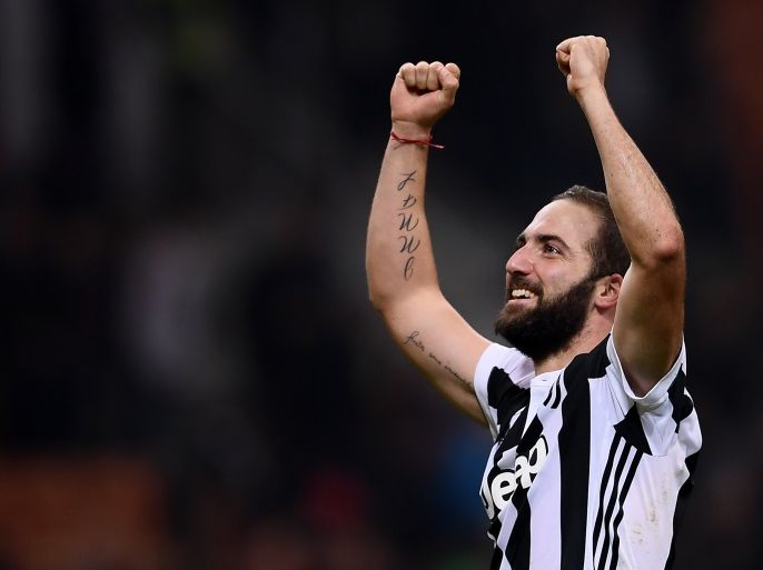 Juventus' forward Gonzalo Higuain from Argentina celebrates at the end of the Italian Serie A football match AC Milan Vs Juventus on October 28, 2017 at the 'Giuseppe Meazza' Stadium in Milan. / AFP PHOTO / MARCO BERTORELLO (Photo credit should read MARCO BERTORELLO/AFP/Getty Images)